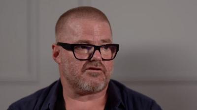 Heston Blumenthal wearing a blue shirt and black frame glasses 