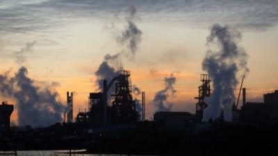 Sun rises behind Tata steelworks in Port Talbot