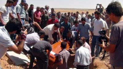 People attend the funeral of drowned Alan Kurdi