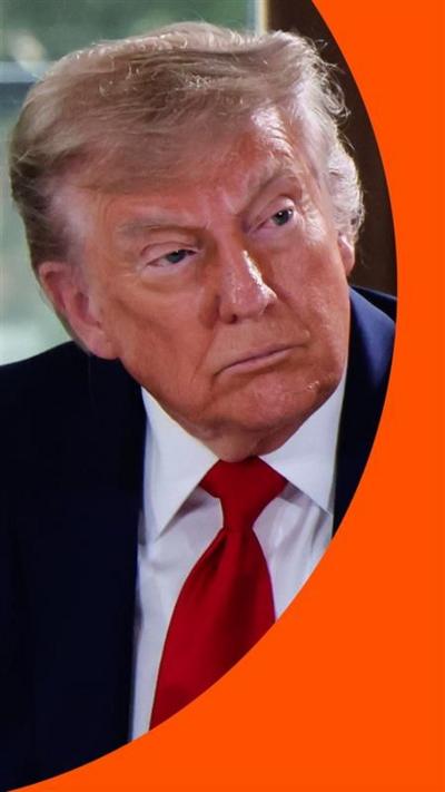 Donald Trump, looking to the right, wearing a red tie.