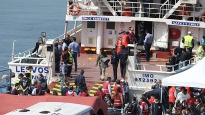 A ferry carrying migrants from Greece arrives at Dikili in Turkey