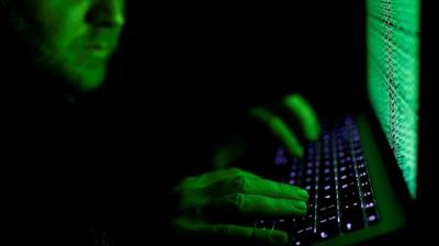 A man typing on a computer keyboard.