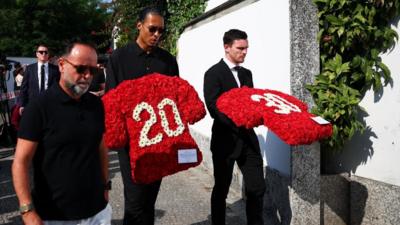Football players arrive at the funeral of Diogo Jota wearing dark clothes.