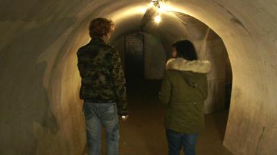 (L) Tour guide Sasha and Carmen Roberts (R) explore Vladivostok's former military tunnels