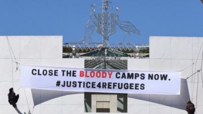 Protest banner outside Parliament House in Canberra