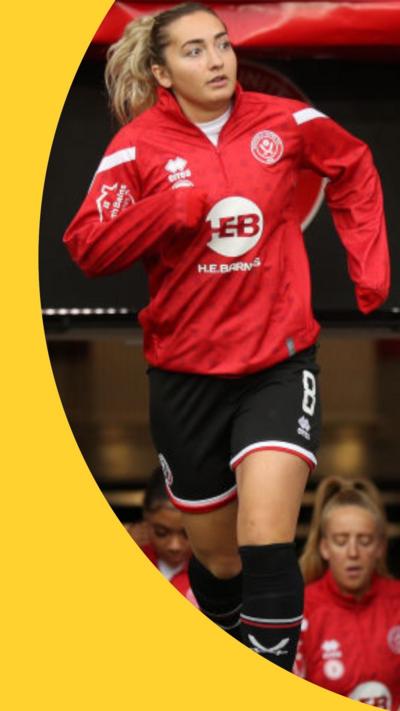 Maddy Cusack running onto a football pitch in a red jersey