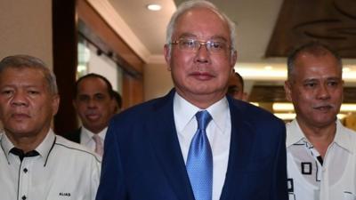 Former Malaysian PM Najib Razak (centre) arrives in court in Kuala Lumpur