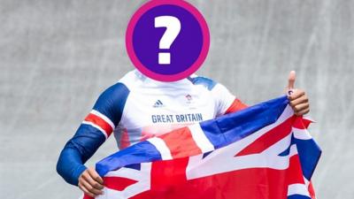 a-person-stands-holding-a-union-jack-flag-but-there-face-is-covered-because-they-are-the-next-dancing-on-ice-contestant-and-we-want-to-keep-their-identity-a-secret