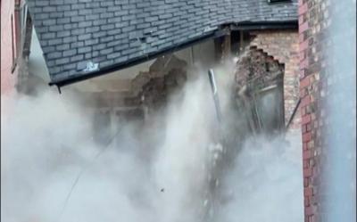 Roof sags as rubbles, brick and dust falls from top floor of building