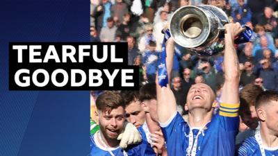 Dean Curry lifts the Irish Cup trophy