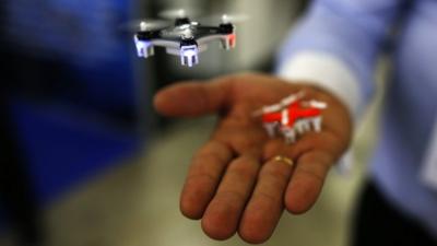 A man shows a mini drone.