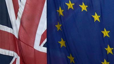 European Union and the British Union flags are seen flying outside of Europe House in London