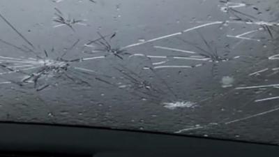 Hailstones smashed car windows.