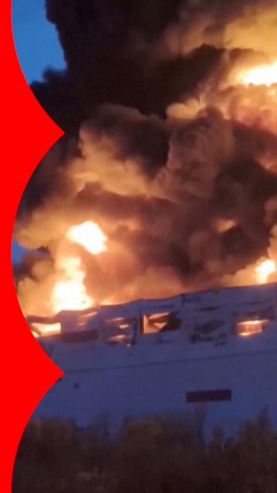 Smoke billows from the roof of a Wildberries factory within Russia