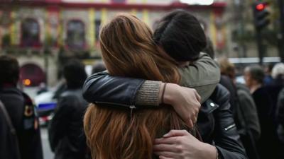 Parisians hug each other in support over the Paris attacks