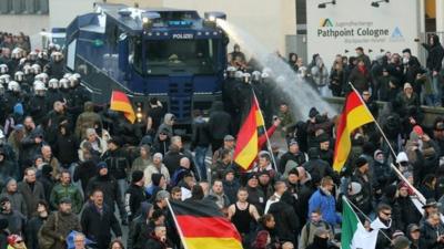 Police fire water cannon at protesters in Cologne