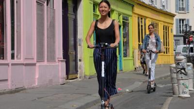 Two women on scooters