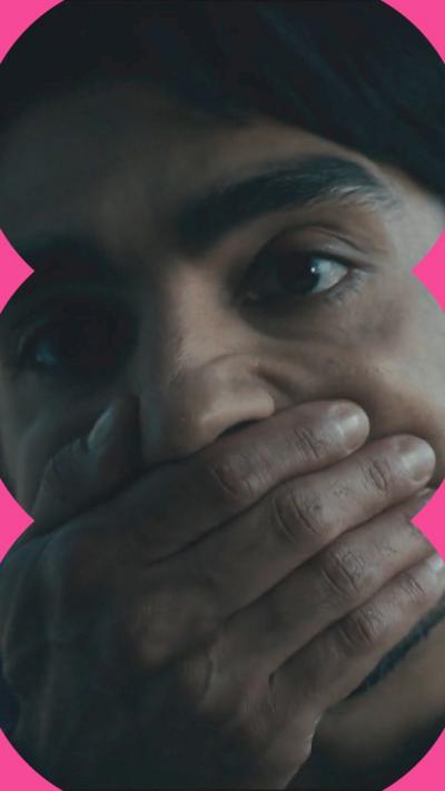 A man covers his mouth with his hand