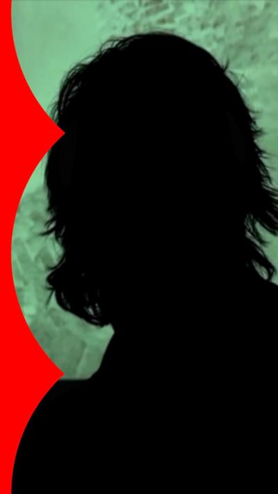 A silhouette of a man against a green background