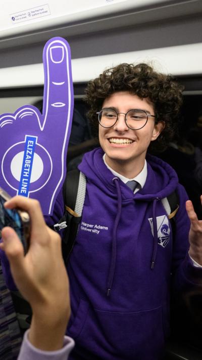 Young man wears a foam finger.