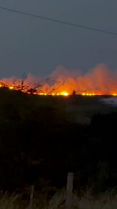 A fire on a hill in low light