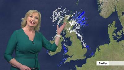 BBC Weather presenter Carol Kirkwood points at a UK weather map with snow over Scotland