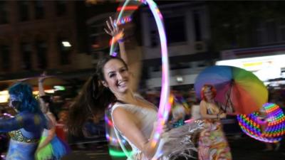 woman dances with a hulk hoop during the annual Sydney Gay and Lesbian Mardi Gras parade in Sydney, Australia