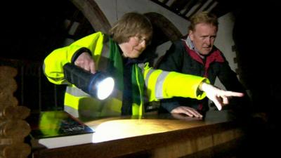 First responder shows John Maguire the flood damage at St Lawrence's Church, Appleby