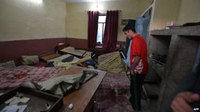 Man looks at bedroom in disarray