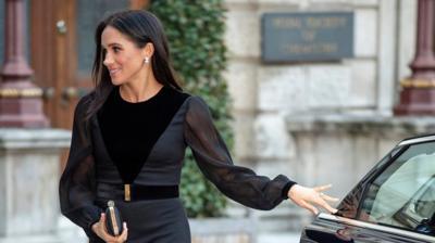 The Duchess of Sussex closes a car door