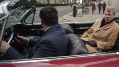 Ted Malloch rides round Westminster in cadillac