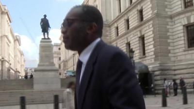 Kwasi Kwarteng walking along the street