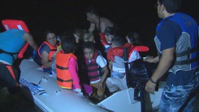 Migrants board a boat to the Greek island of Kos