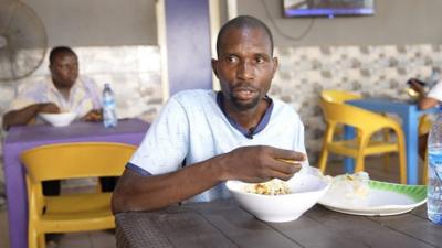 A man eating at a local eatery