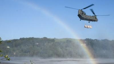 An RAF helicopter has been brought in to help repair a damaged reservoir which threatens to flood a town.