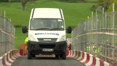 Minibus crosses bridge