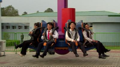 North Koreans on a ride at a funfair