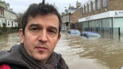 Matthew Price on flooded street