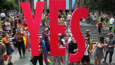 People celebrate after the announcement of the same-sex marriage postal survey result in front of the State Library of Victoria in Melbourne, Australia, 15 November 2017.