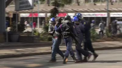 Police drag away protester