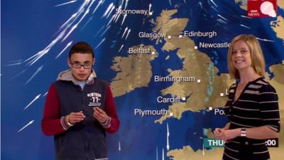 A school child and Sarah Keith-Lucas in front of a weather map