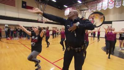 Officer dancing at school