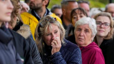 Mourners react during the funeral service for Queen Elizabeth II at Westminster Abbey