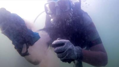 A scuba diver cleaning the ocean