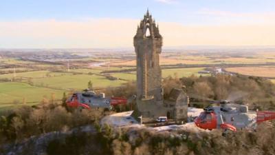 Sea King helicopters fly by the Wallace Monument