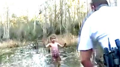 Girl in swamp and law enforcement official