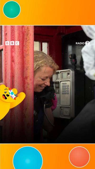 Sara Cox in a phone box