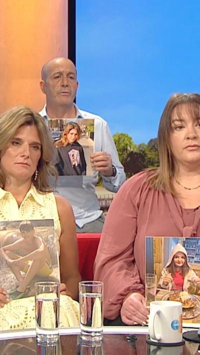 Parents holding images of their deceased children