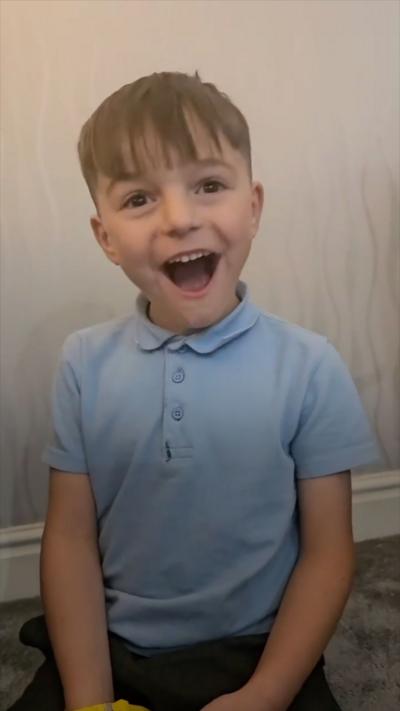 Young boy looking happy in a light blue tee-shirt