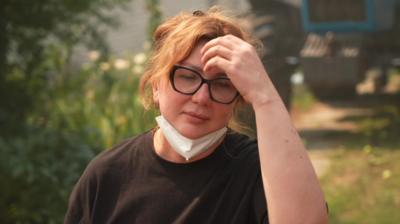 Anastasiia Dudley with her hand on her head